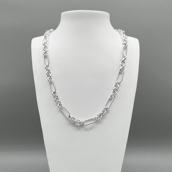 A photo of the Soiree chain in fine silver, displayed on a white bust in front of a grey background.